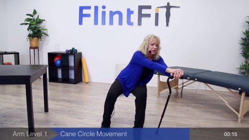 occupational therapist leaning on cane for passive exercise