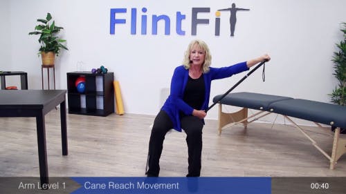 therapist using cane to stretch arm