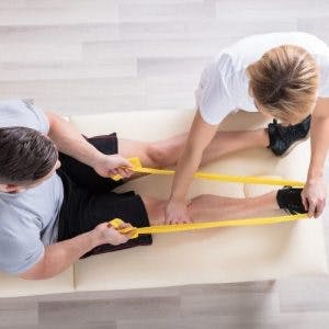 physical therapist working with leg exercises for stroke patients