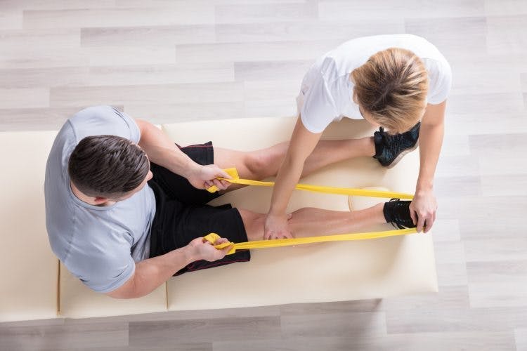 physical therapist working with leg exercises for stroke patients