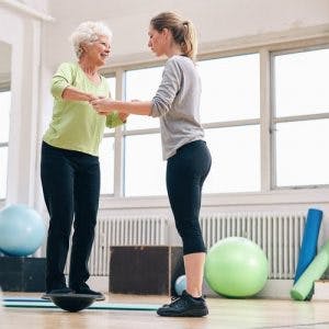 therapist helping stroke patient balance during inpatient rehab