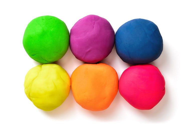 six colorful pieces of therapy putty rolled into perfect balls