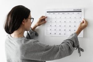 Woman hanging up a calendar to help get her life back on track after brain injury