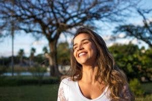 young woman smiling in sunlight