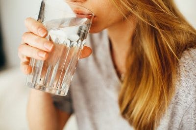 girl with spinal cord injury drinking water as part of bowel program
