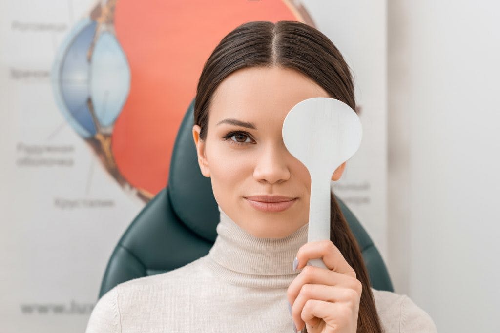 woman covering one eye so she can practice eye exercises for concussion