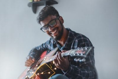 man playing guitar as one of his activities for brain injury patients