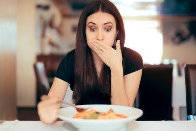 Woman trying to taste pasta after she lost her sense of taste and smell after head injury