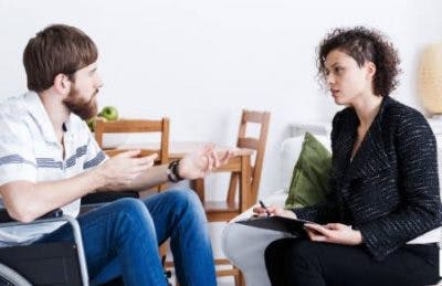man talking with therapist about the emotional effects of brain injury