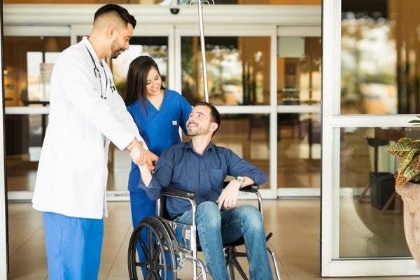 Patient leaving the hospital on a wheelchair after understanding complete vs incomplete spinal cord injury