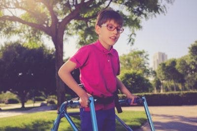 young boy with crouch gait practicing walking