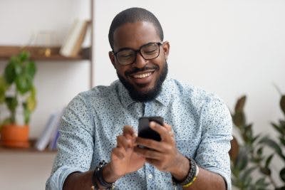 Man smiling while using brain injury cognitive training app