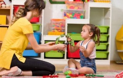 young girl with cerebral palsy playing with musical instruments to improve motorcontrol