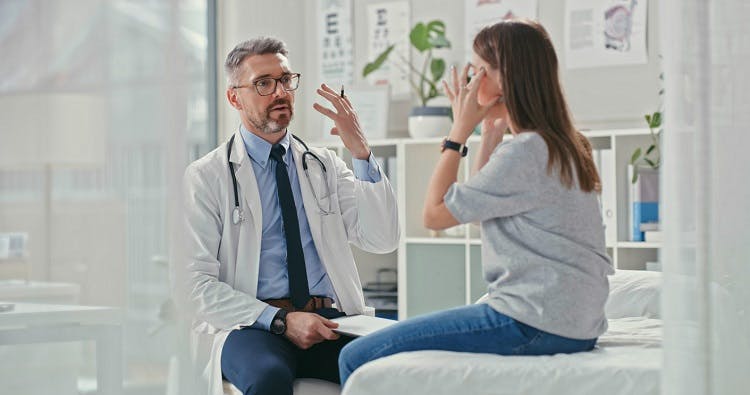 Doctor discussing with patient the risk factors of ocular migraines and stroke
