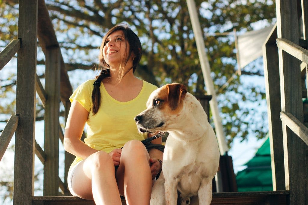 TBI service dog and owner sitting on porch