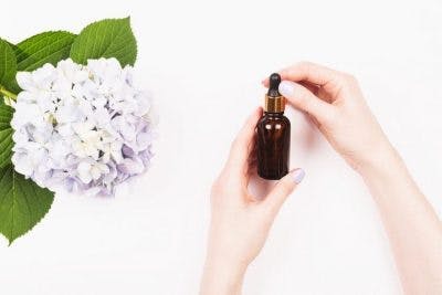 woman holding amber bottle of magnesium oil gift for stroke patients