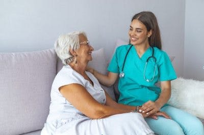 patient with neuropathy after stroke getting emotional support from friendly nurse