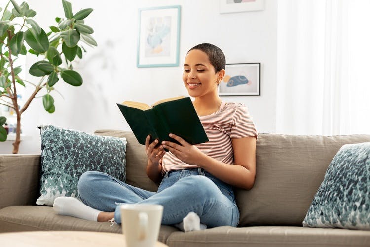 woman sitting on the couch learning to read after brain injury