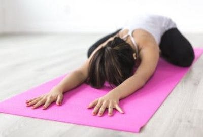 woman doing yoga as her occupational therapist suggests