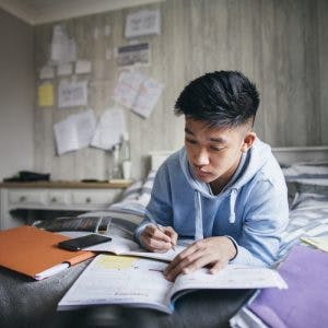 person studying from various books after brain injury