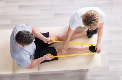 therapist working with patient to fix curled toes with exercises