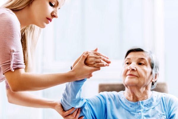 physiotherapist helping stroke survivor with fine motor activities for adults