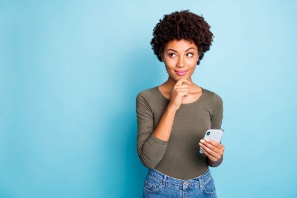 Woman Holding Phone and Thinking About Cognitive-Communication Therapy Activities