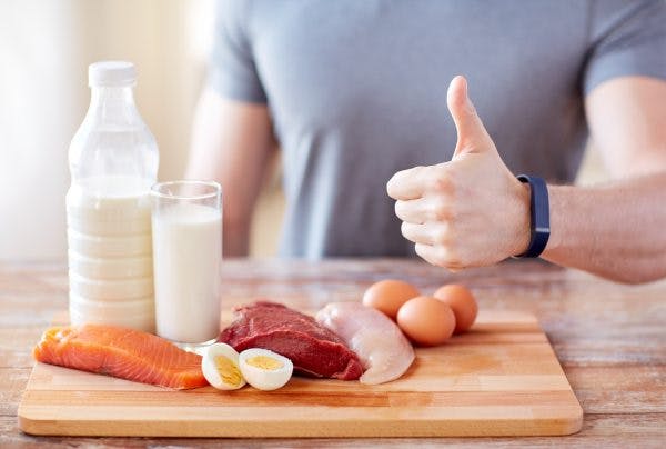 man with food rich in vitamin B12 for brain injury showing thumbs up
