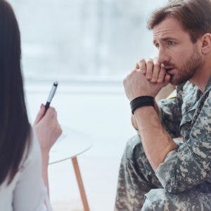 soldier listening to doctor describe blast-induced traumatic brain injury