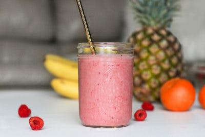 smoothie on table in front of pineapple and banana. Smoothies can counter weight loss after brain injury