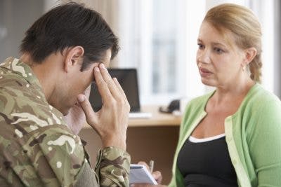 soldier talking to doctor about blast-induced traumatic brain injury symptoms