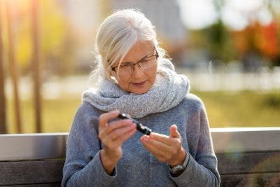 woman with diabetes and brain injury checking glucose level