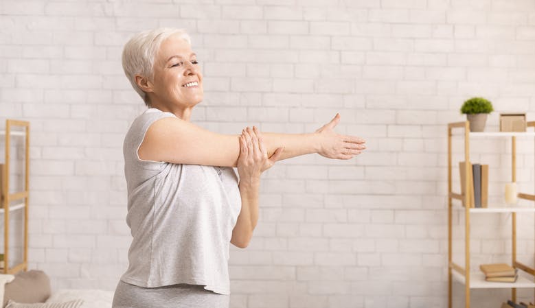 Woman performing the side stretches of her hands while turning the