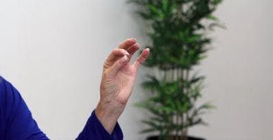 occupational therapist touching thumb to index fingertip for hand exercise