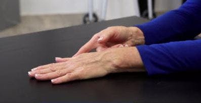 occupational therapist with palm down on table