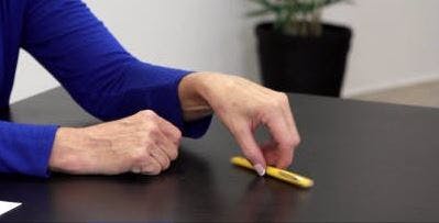 therapist showing hand exercises for stroke patients