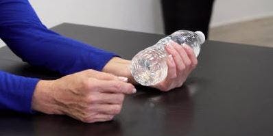therapist squeezing water bottle in hand