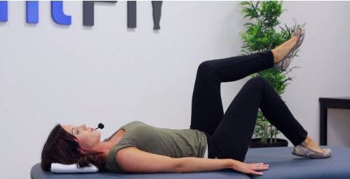 physical therapist demonstrating gait training exercises on therapy table