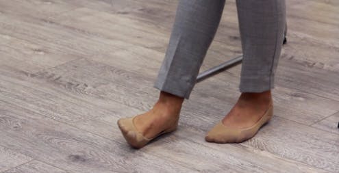 therapist lifting edge of foot up off the ground for foot drop exercises