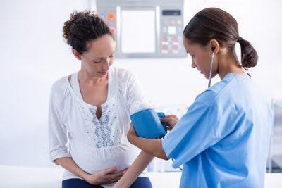 doctor taking blood pressure reading for stroke patient to help prevent a second stroke