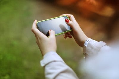 Woman playing puzzle game on smartphone