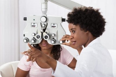 optometrist evaluating patient with blurred vision in one eye after head injury