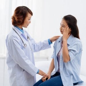 doctor talking to a survivor about experiencing a headache after stroke