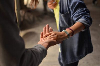 close up of woman grabbing hand of man