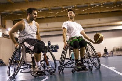 man playing basketball in wheelchair 