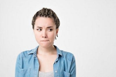 woman biting lip and looking shy from not talking after stroke