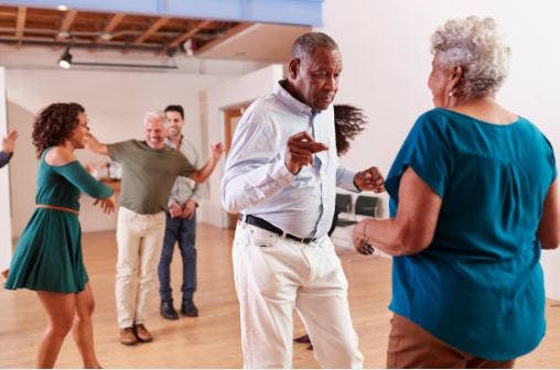 stroke patients in dance room dancing slowly together