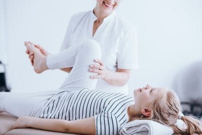 girl with spinal cord injury getting treatment for clonus