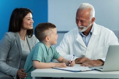 doctor talking to pediatric stroke survivor and mother