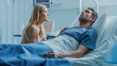 wife watching for signs of neurostorming in unconscious husband